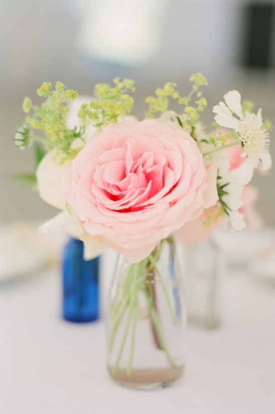 Pink rose and other flowers in a clear glass vase