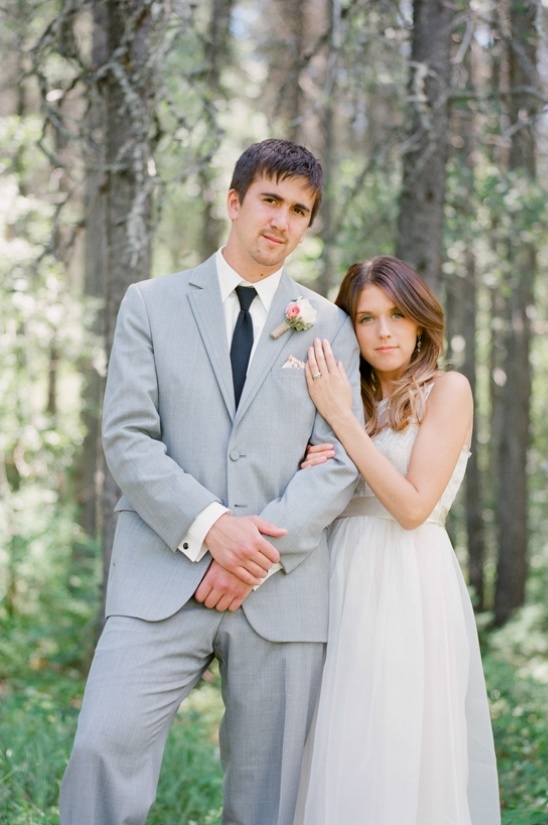 Newly married couple posing in a forest landscape
