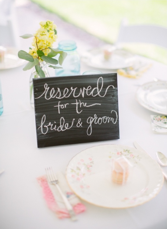 Wedding table setting with a reserved sign for bride and groom