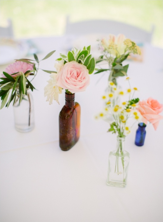 Pastel roses and wildflowers in vintage bottles