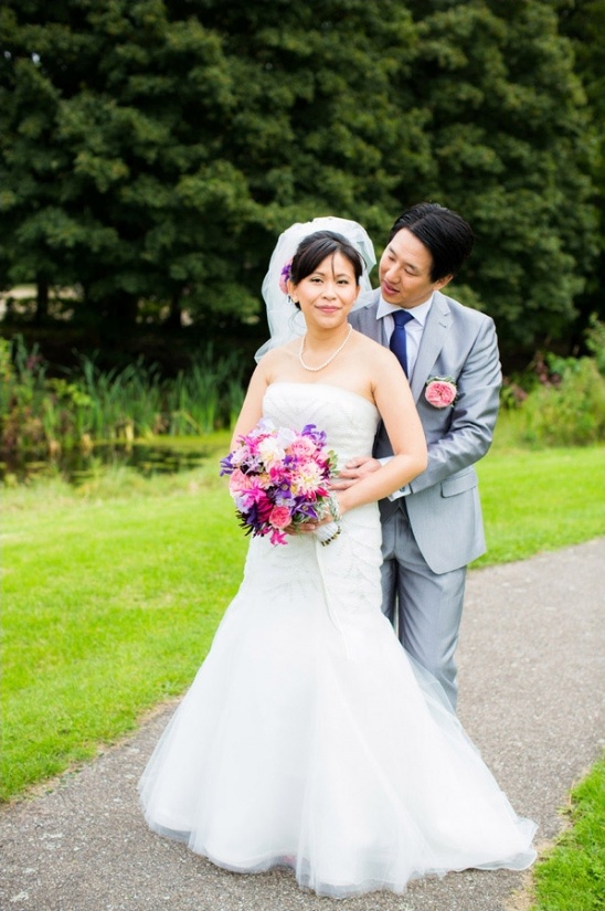 Beautiful Asian couple poses together at a wedding ceremony