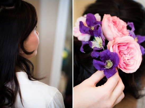 Woman with floral hairpiece in dark hair getting ready