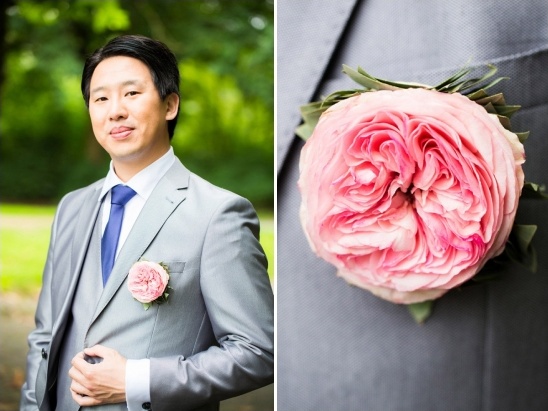 Asian man in suit with a pink rose boutonniere for a wedding