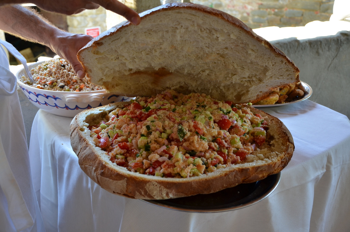 Fresh salad served in a giant bread bowl, delicious and rustic