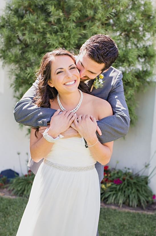 Happy bride and groom embracing on their wedding day, smiling