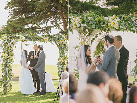 Jewish wedding ceremony under a beautiful floral arch outdoors