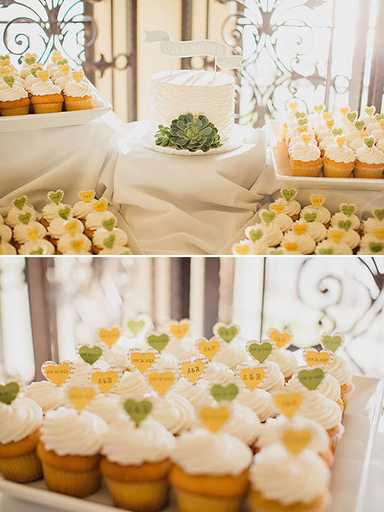 Wedding cake and cupcakes decorated with heart toppers