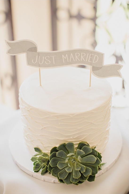 Wedding cake with Just Married banner and succulent decoration