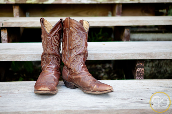 Pair of brown cowboy boots resting on wooden steps