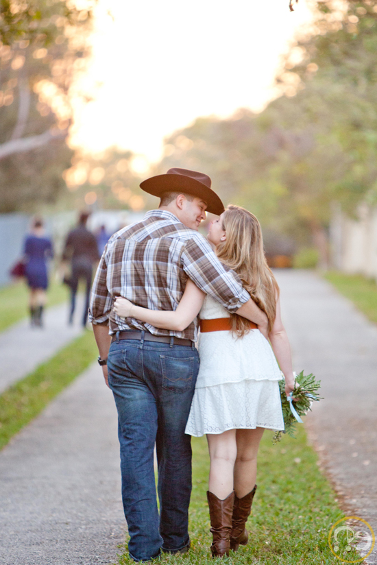 Romantic couple walking and sharing a tender moment outdoors at sunset