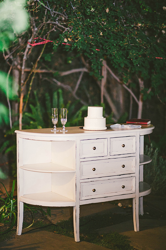 Elegant white wedding cake and champagne glasses on a table