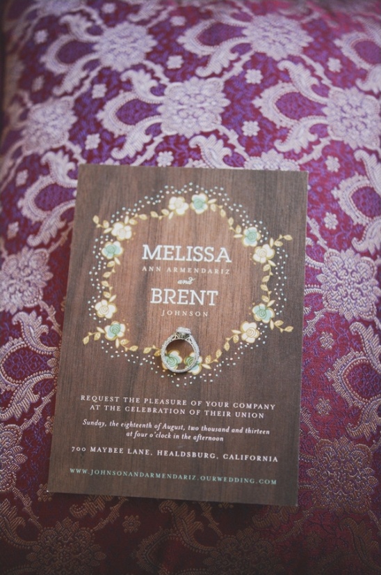 Wedding invitation with ring on a decorative purple pillow