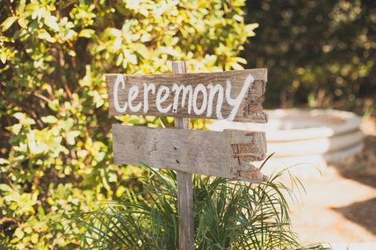 Ceremony sign pointing the way at an outdoor wedding event