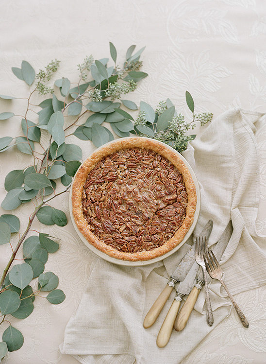 Delicious pecan pie with fresh foliage and silverware