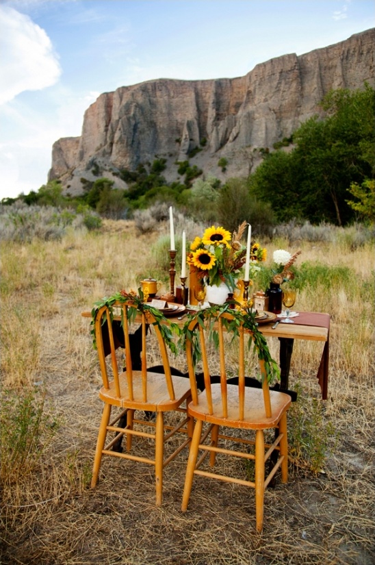 Rustic outdoor wedding table setting with sunflowers