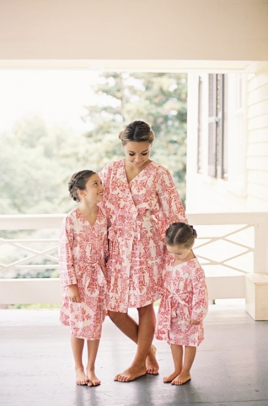 Mother and daughters in matching robes, happy family