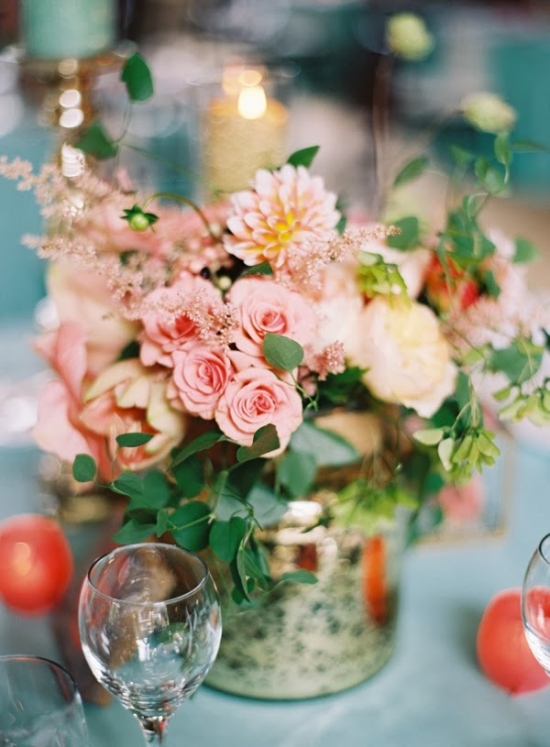 Elegant floral centerpiece with pink roses and wine glasses