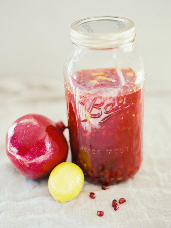 Pomegranate juice in glass jar with lemon