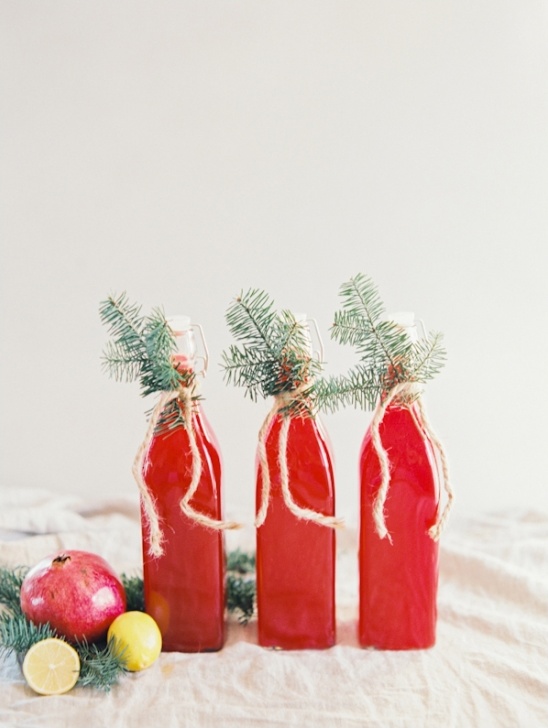 Red Christmas drinks with pine sprigs