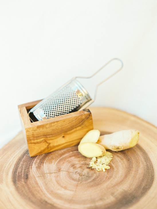 Wooden grater with ginger slices