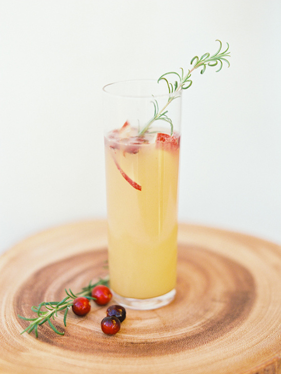 Apple cider drink with cranberries and rosemary