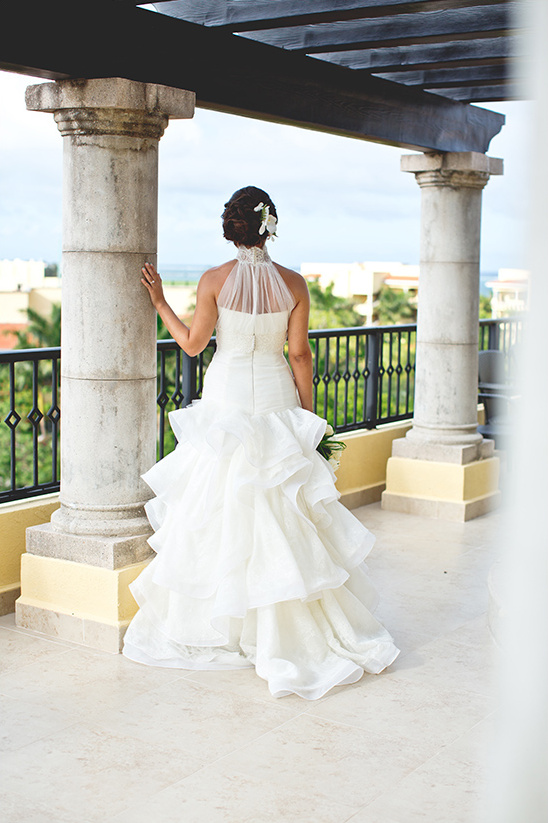 Bride in elegant tiered wedding gown