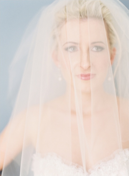 Bride veiled in elegant wedding gown