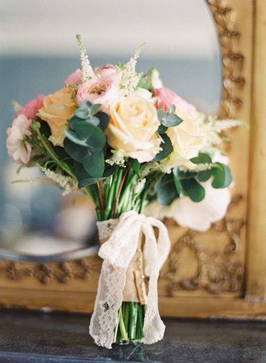 Elegant peach and pink rose wedding bouquet with lace