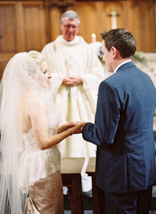 Bride and groom exchanging rings during wedding ceremony