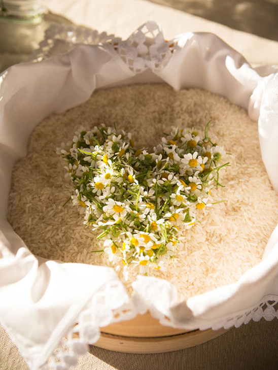 Heart shaped daisies in rice for wedding decoration