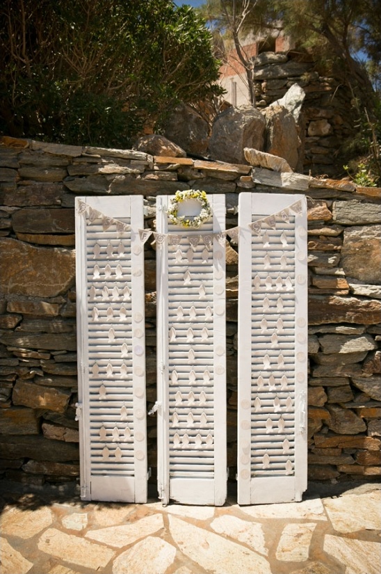 Rustic wedding decoration with shutters and stone wall