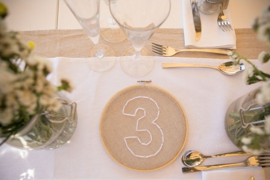 Wedding table setting with number three centerpiece