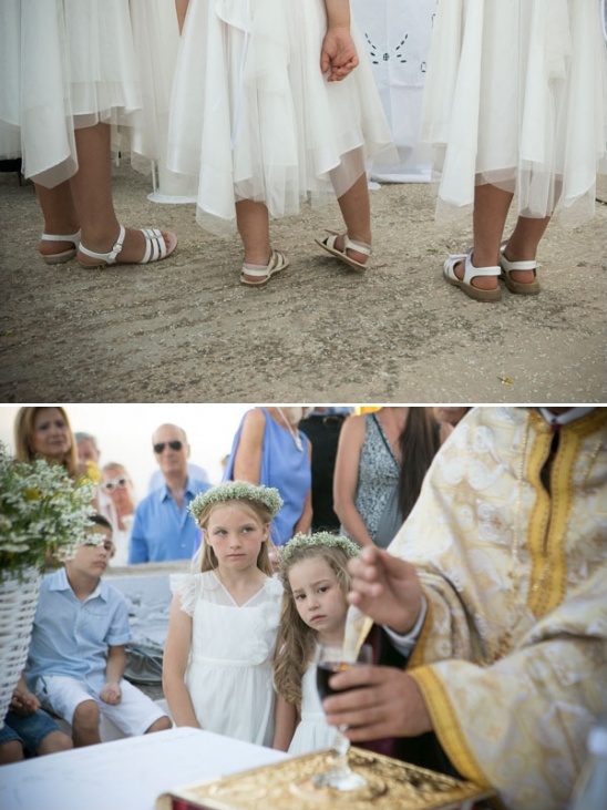 Flower girls in white dresses and sandals at wedding