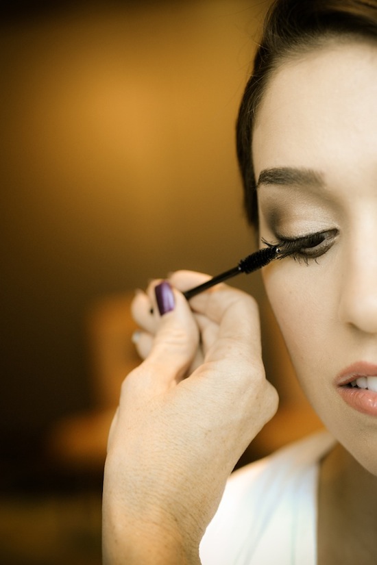 Bride getting mascara applied for wedding makeup