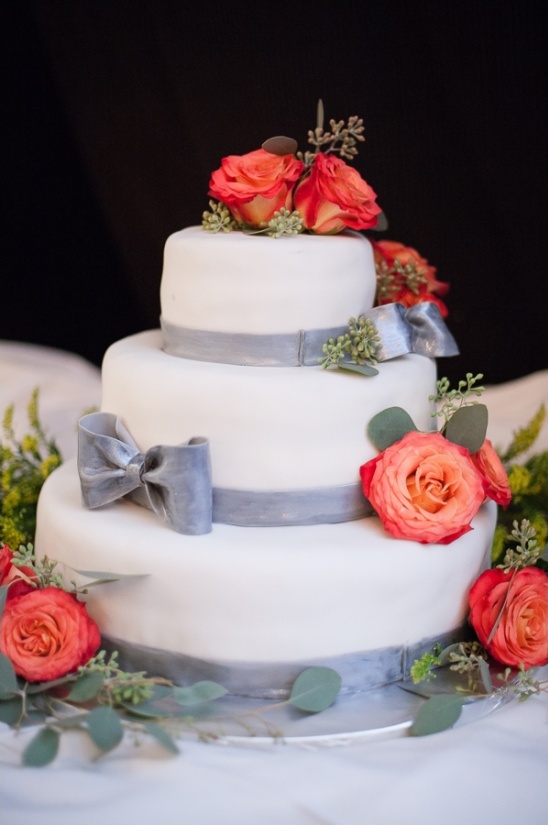 gray and white cake with rose decorations