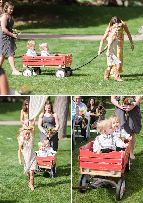 ring bearers in a red wooden wagon