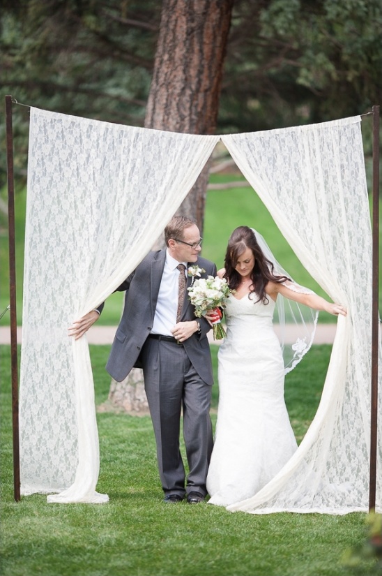 bride entering through lace curtain