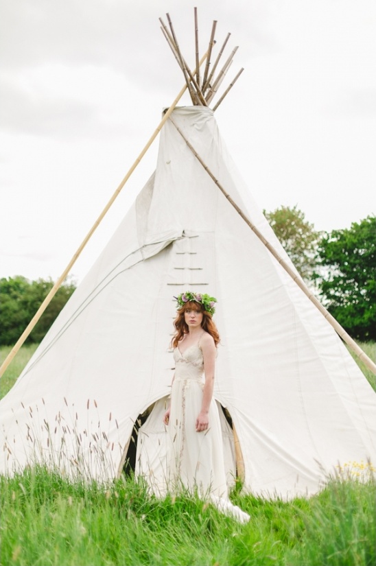 Redhead bride with floral crown at tipi wedding venue