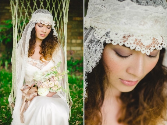 Bride in vintage lace veil wedding dress outdoors