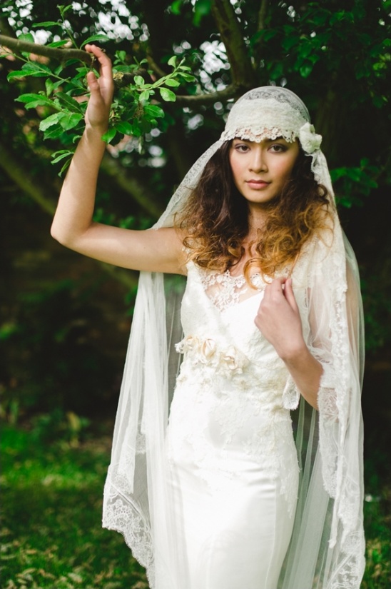 Boho bride wearing vintage lace wedding dress and veil