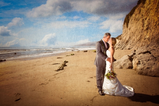 Romantic beach wedding couple kissing near cliffs
