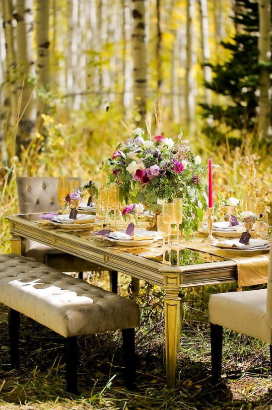 Rustic autumn wedding table setting in aspen grove