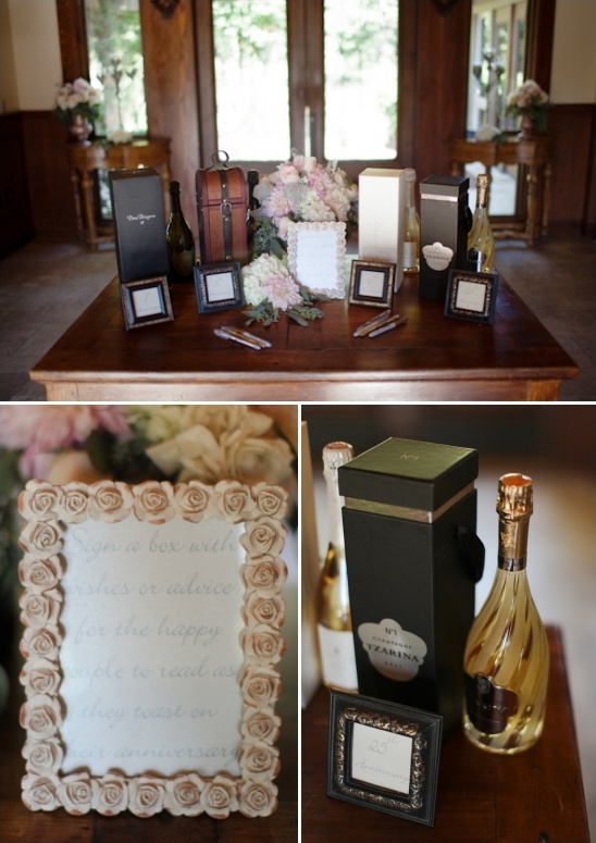 Wedding guest book champagne display on wooden table