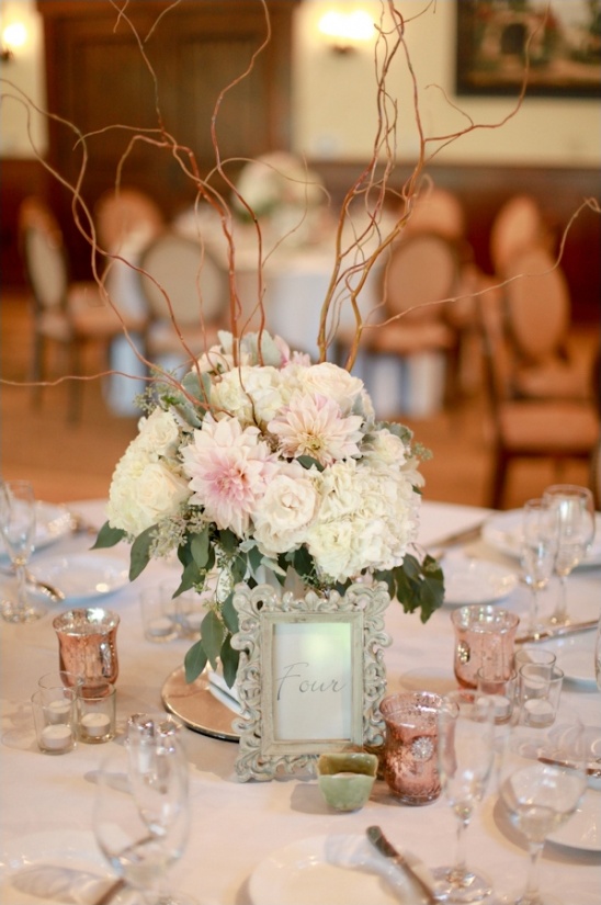 Elegant wedding table centerpiece with flowers and branches