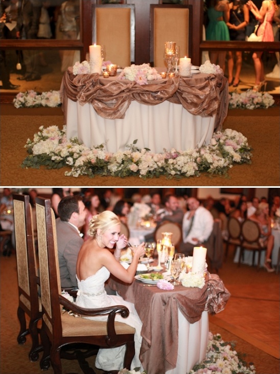 Romantic wedding sweetheart table with floral decor