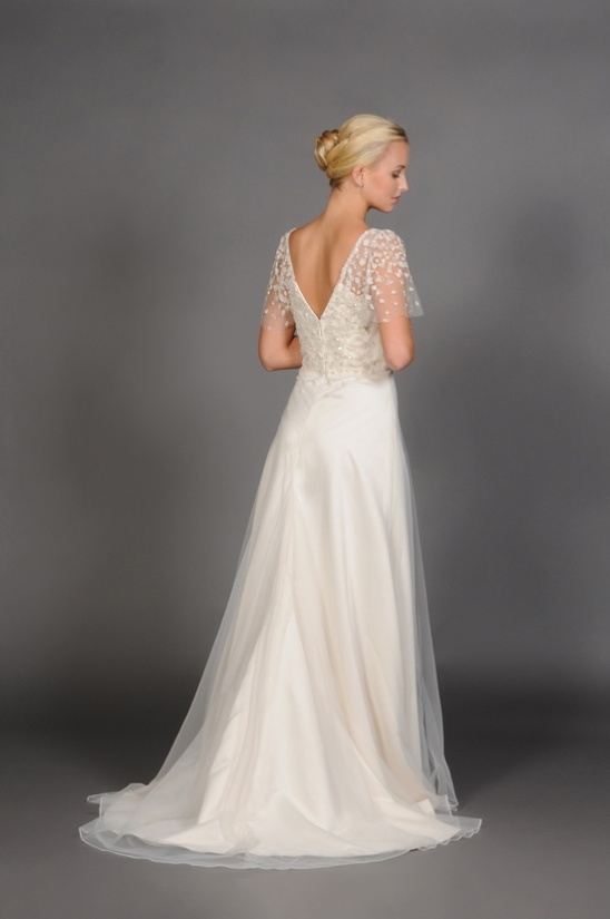 Elegant ivory wedding gown with beaded bodice and tulle overlay