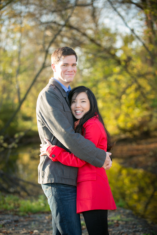 Couple embracing outdoors with autumn foliage