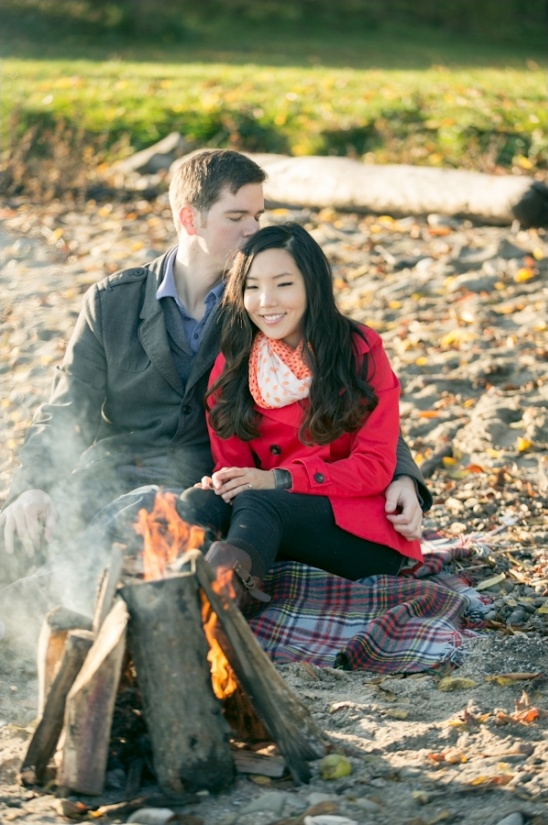 Couple cuddling by a cozy autumn bonfire