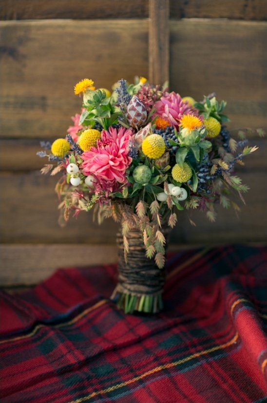 Colorful flower bouquet on tartan blanket still life