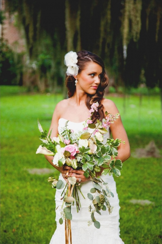 Beautiful bride with floral hair and bridal bouquet